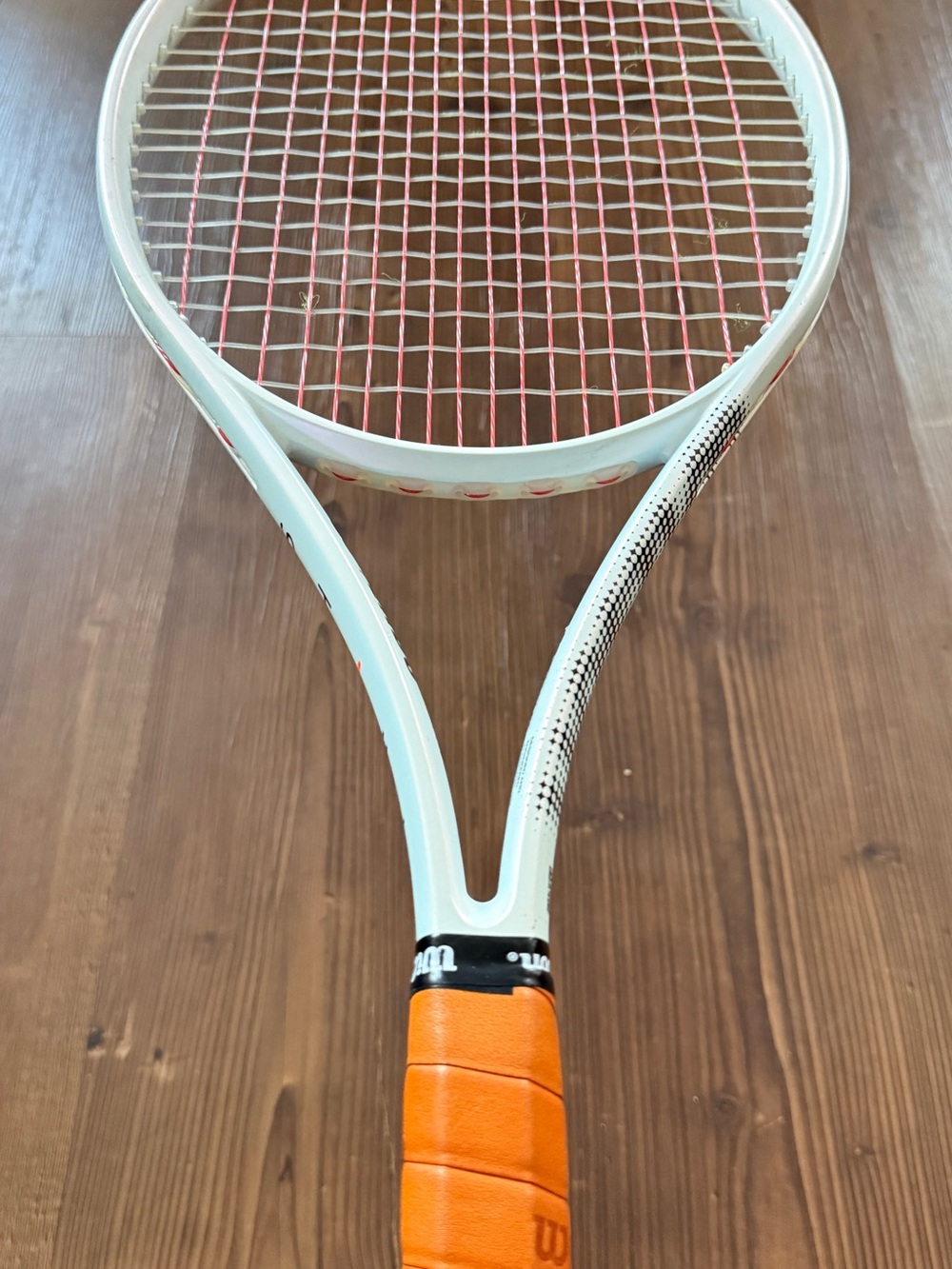 Wilson Light Blue Tennis Racket with Orange Grip